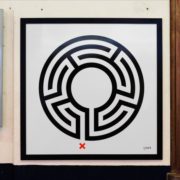 Labyrinth artwork by Mark Wallinger. A black and white image on a labyrinth on a plaque at Chesham station.