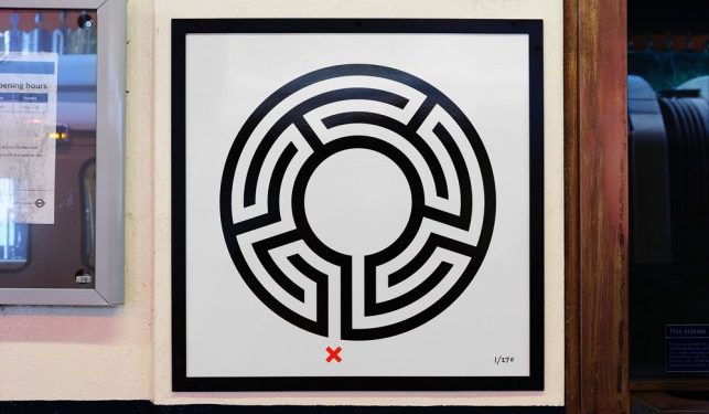 Labyrinth artwork by Mark Wallinger. A black and white image on a labyrinth on a plaque at Chesham station.