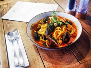 hdrpl Bowl of spaghetti and mussels, rustic table setting