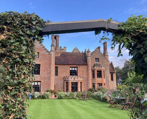View through arch of Chenies Manor and beautiful gardens