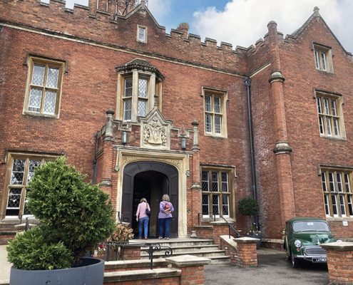 latimer house entrance-800x600 Front of Latimer House with two guests walking up the steps; vintage car in foreground