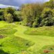 Chesham and Ley Hill course with golfers in the distance, surrounded by trees