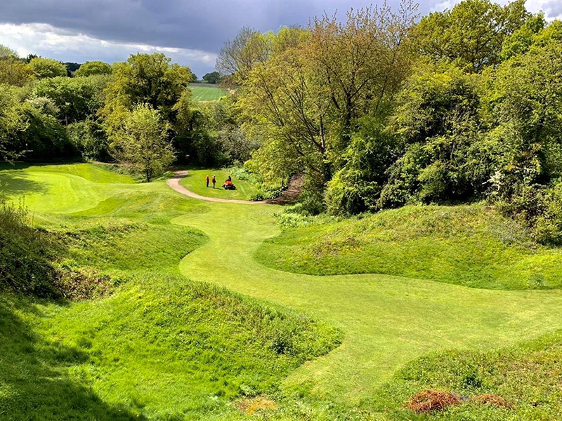 Chesham and Ley Hill course with golfers in the distance, surrounded by trees