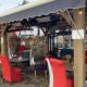 Outdoor seating under cover outside The Drawingroom. high backed red chairs, warm lighting