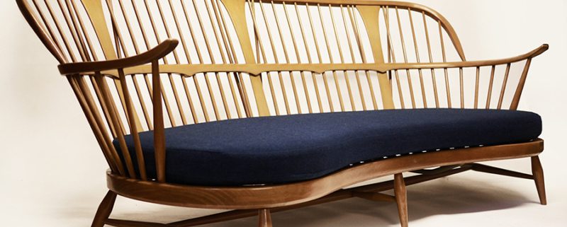 Ercol vintage sofa on pale background