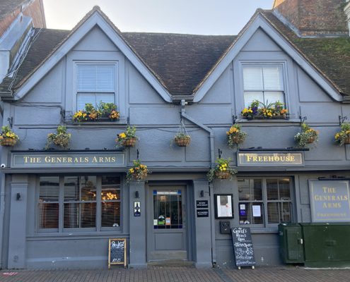 The Generals Arms pub exterior - slate grey painted, gold lettering and hanging baskets