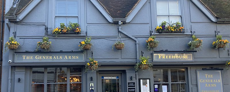 The Generals Arms pub exterior - slate grey painted, gold lettering and hanging baskets
