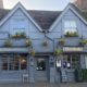The Generals Arms pub exterior - slate grey painted, gold lettering and hanging baskets