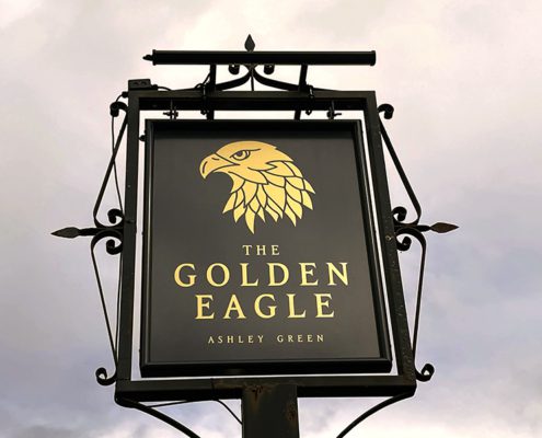 Pub sign for t/he Golden Eagle- gold eagle head on black background