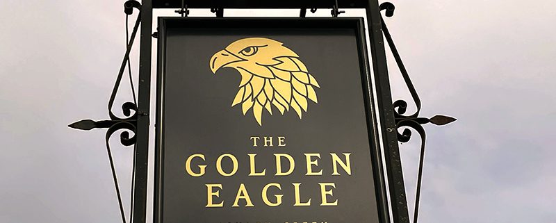 Pub sign for t/he Golden Eagle- gold eagle head on black background