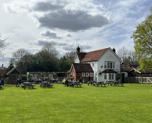 View of the benches and pub garden looking towards back of Blue Ball pub, Asheridge