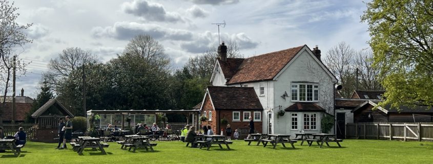 View of the benches and pub garden looking towards back of Blue Ball pub, Asheridge