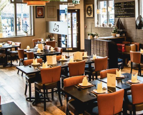 Jasmine Thai interior with table swettings, warm oranges and browns