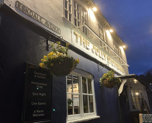 Exterior of Jolly Sportsman pub at night