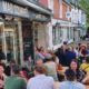 Mad squirrel frontage with many people sitting outside at rthe tavbles looking happy