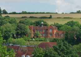 White Hill Centre a large Victorian building viewed from Lowndes Park, with fields behind