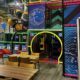 indoor soft play area with wooden tables in foreground