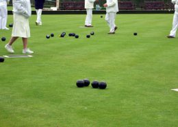 Image of lawn bowls games and players feet