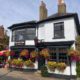 Exterior of the red Lion pub in Chenies, with hanging baskets