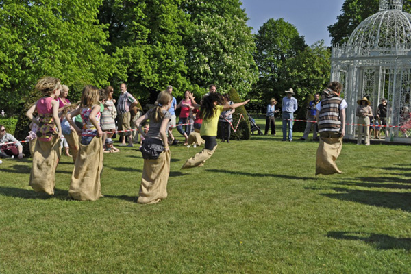Children taking part in sack race across lawn at Chenies Manor