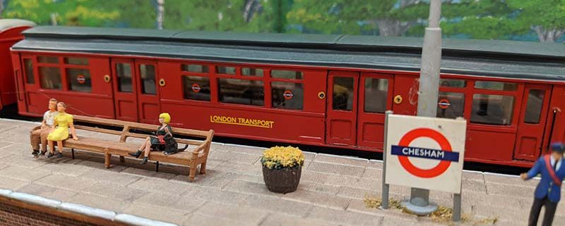 Model of train and platform at Chesham station with passengers and guard
