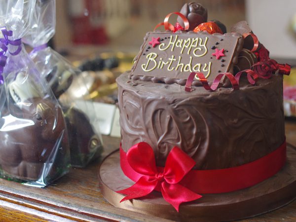 Birthday cake made by Sophies chocolates with red ribbon